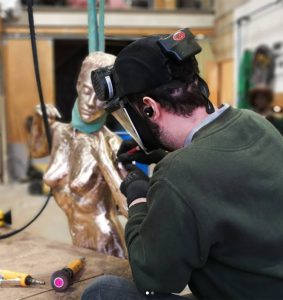 Pat working on a life size female figure by artist Andrew Freidin